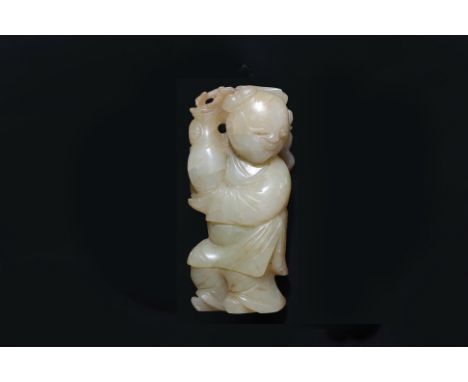 A CELADON AND RUSSET JADE CARVING OF A BOY
Modelled standing, holding a vase of flowers, the reverse with russet inclusions
6