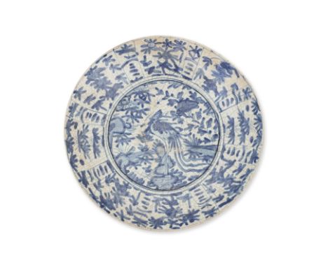 A LARGE SWATOW BLUE AND WHITE DISH
Late Ming dynasty, decorated in central crane among foliage, panelled foliate cavetto
38cm