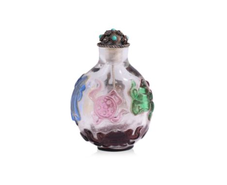 A MULTI-COLOURED OVERLAY AND CLEAR GLASS 'BUDDHIST EMBLEM' SNUFF BOTTLE
Circular form bottle decorated in relief carving of e