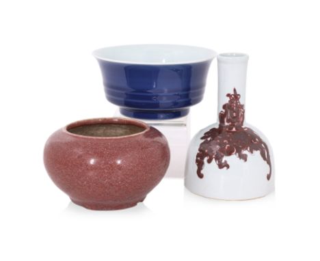 A GROUP OF THREE PORCELAIN WARES
20th Century, a monochrome blue bowl with ribbed sides and everted rim, a red glazed brush w