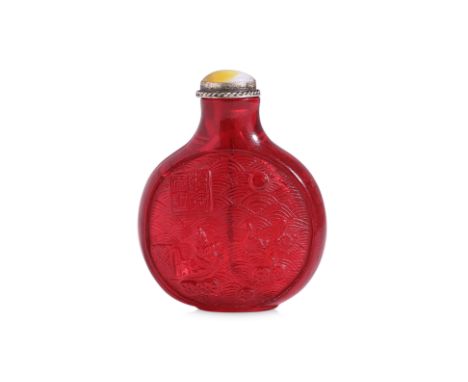 AN INSCRIBED RUBY-RED CARVED SNUFF BOTTLE
Compressed circular form bottle with well hollowed interior, decorated in relief pa