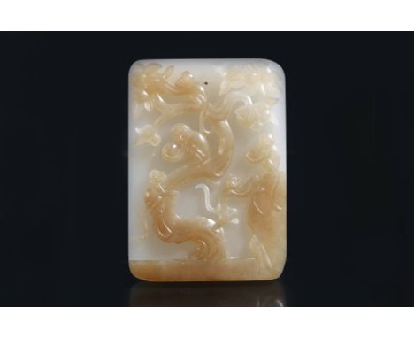 A WHITE AND PALE RUSSET JADE PENDANT PLAQUE OF MONKEYS
Carved in high relief to teh front with five monkeys in a peach tree, 