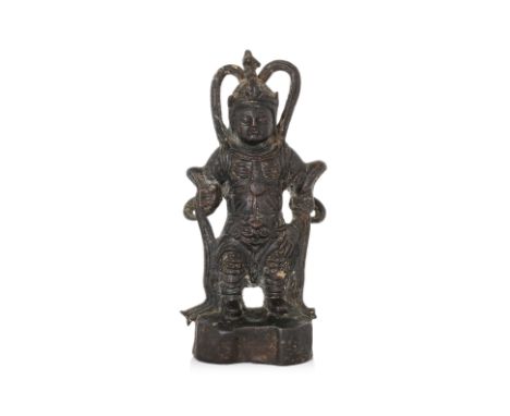 A STANDING BRONZE FIGURE WITH INSCRIPTION Ming dynasty, modelled with eyes closed and right hand raised, wearing armour and c