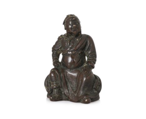 A SMALL SEATED BRONZE FIGURE OF GUANDI Ming dynasty or earlier, modelled sitting with legs apart, wearing flowing robe over a