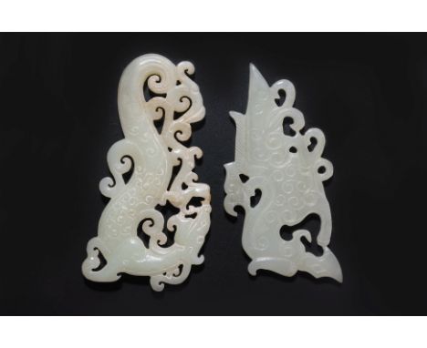 TWO RETICULATED JADE CARVINGS
Pale celadon modelled as a dragon confronting a smaller dragon, relief carved detail to the bod