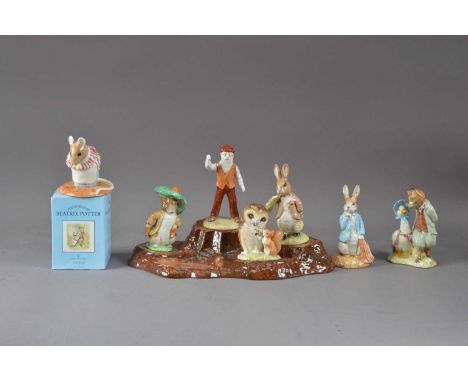 An assorted collection of Beatrix Potter ceramics, comprising Royal albert figurines, a Beswick tree trunk base 30cm wide and