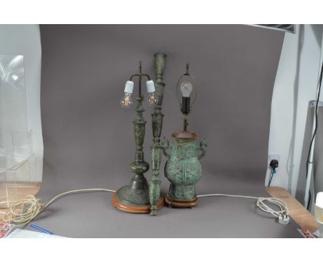 Two modern Chinese bronzed lamps, in the antique style, both approx. 75cm high, together with a section of a lamp base 88cm (