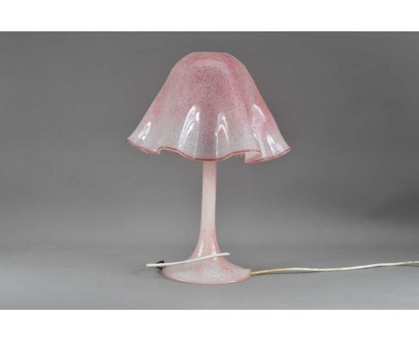 A cranberry glass lamp and shade, the shade with a crimped rim, total height 46cm, together with a small shade, 17cm high, da