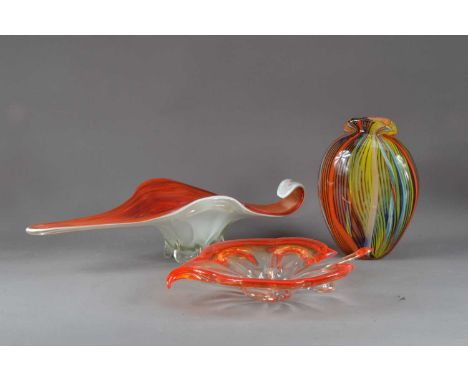 Three items of studio glass, comprising a shaped centre-piece, an orange leaf shaped platter, 39cm length and a multi-coloure