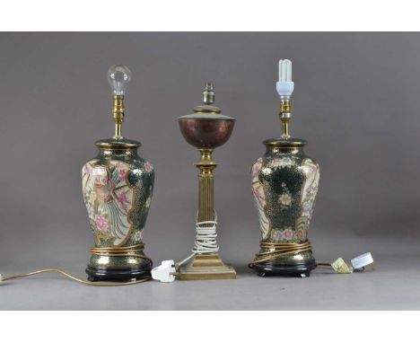 Three lamps, comprising a modern ceramic pair with green and gilt glaze, on wooden bases, 41cm high and a brass example, conv