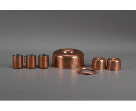 A small collection of Victorian copper kitchen wares, comprising three jelly moulds, the largest 13cm in diameter with engrav