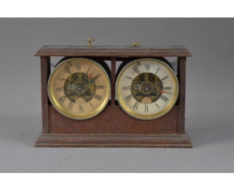 An early 20th century 'Reliable Chess timer' in an oak case, by W.E. Tanner assembled in Redhill Surrey, with two dials both 