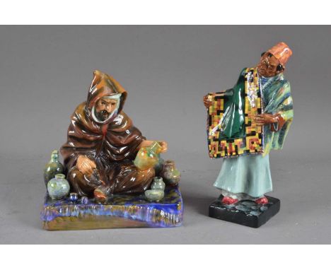 Two Royal Doulton ceramic figurines, comprising The Potter and The Carpet Seller, both marked to the undersides (2)