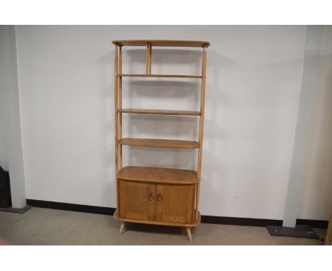 A c1970s Ercol bookcase and storage unit, 191cm high and 90cm wide, staining and some damagesAS MENTIONED THERE ARE SOME STAI