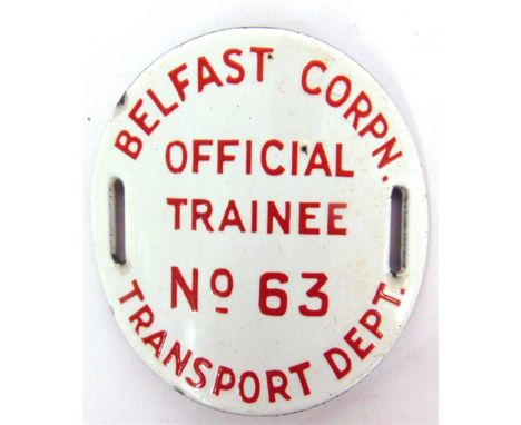A BELFAST CORPORATION TRANSPORT DEPARTMENT OFFICIAL TRAINEE ENAMEL ARM BADGE  numbered 63, with red lettering against a white