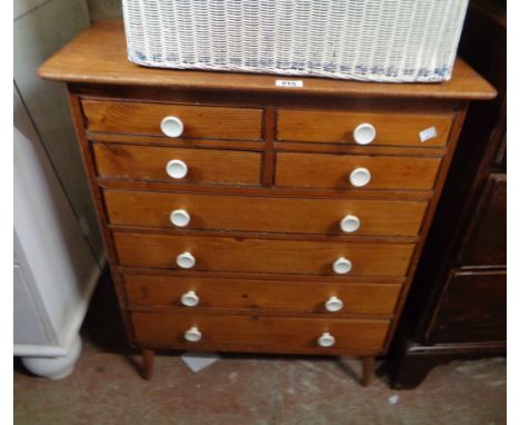 A 66cm vintage pine chest of four short and four long graduated drawers, set on tapered legs