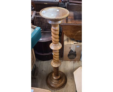 A vintage stained beech jardinière stand, set on a barley twist pillar and circular base
