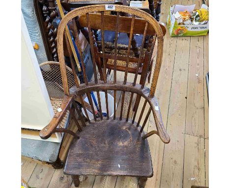 An 18th Century hoop stick back Windsor elbow chair with solid elm moulded seat, set reduced turned legs - wear