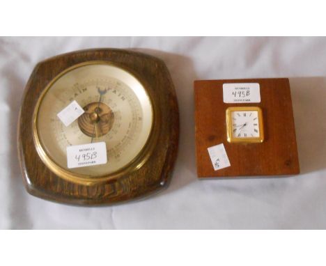 A vintage oak framed wall barometer with visible aneroid works - sold with a watch style timepiece with battery movement