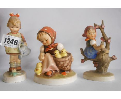 Three Hummel figurines, each depicting children in various pursuits