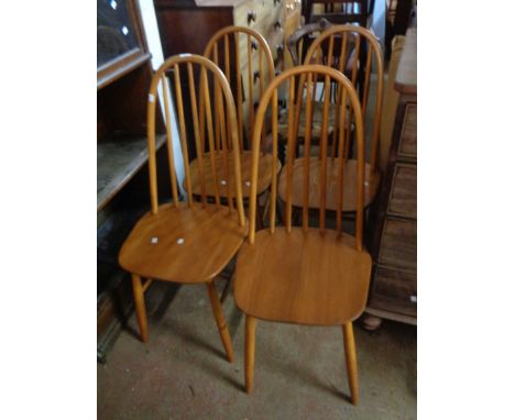 A set of four vintage Ercol light wood hoop stick back dining chairs with moulded sectional seats, set on simple turned suppo