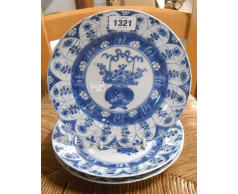 Three Chinese Kangxi porcelain plates, the covetto with blue painted urn and flowers, and a floral panel border
