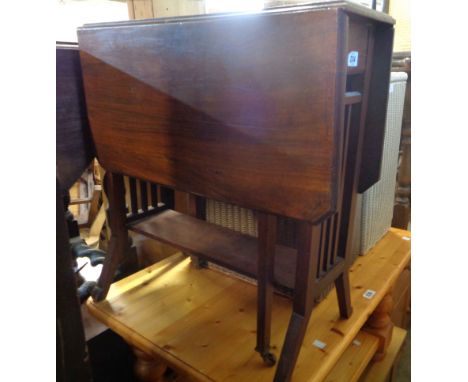 A 61cm Edwardian walnut Sutherland table with slatted ends, set on splayed feet