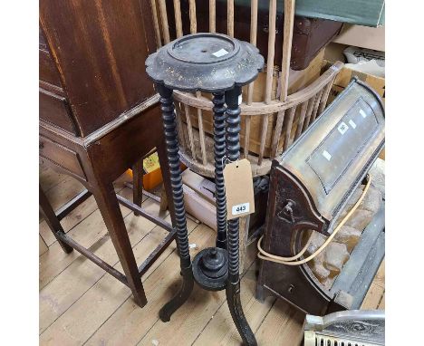 A late Victorian ebonised wood stand with remains of gilt decoration, set on triple bobbin turned supports and splayed legs