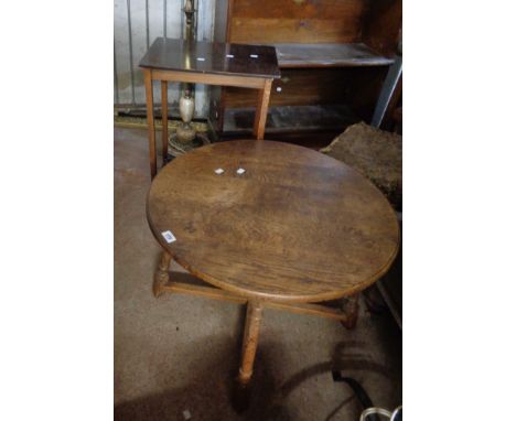 A 67cm diameter early 20th Century oak tea table, set on a turned supports and X-stretcher - sold with an oak two tier occasi
