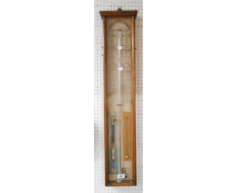 An old Admiral Fitzroy barometer in glazed oak cased with printed back scale, two mercury tubes and remains of atmosphere tub