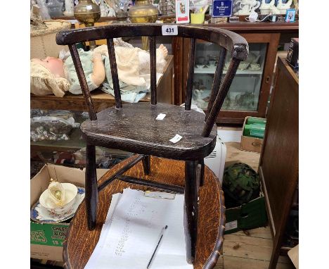 A painted wood child's stick back bow chair with solid elm seat panel, set on simple turned supports