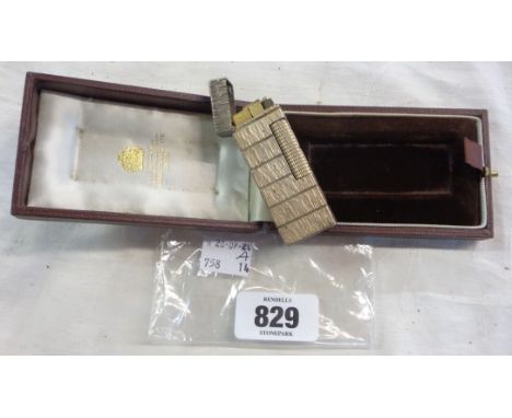A vintage Dunhill lighter set in brown fitted case