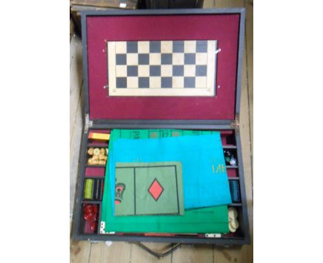 A vintage cased games compendium including cribbage board, dominoes, etc.