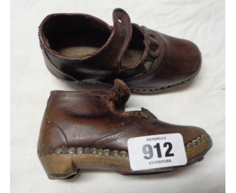 A pair of antique Lancashire christening clogs with leather upper, button top and wood and metal sole