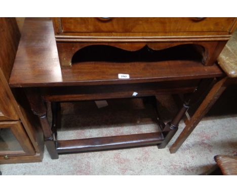 An 80cm antique mahogany side table with drawer to one end, set on turned supports and open stretcher base - later varnished 