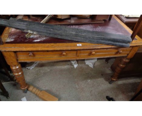 A 1.34m Edwardian oak library table with remains of leather inset top, two frieze drawers and opposing similar, set on turned