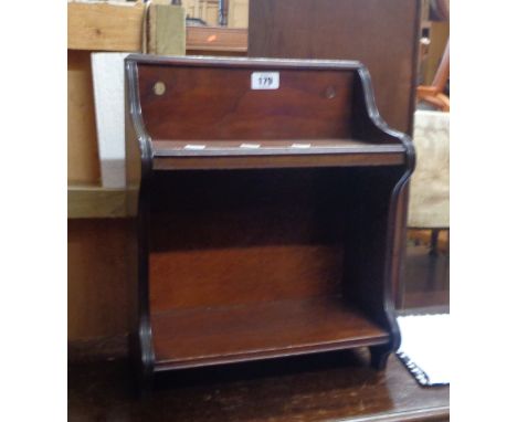 A small mahogany wall hanging two shelf unit