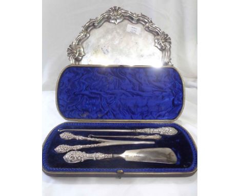 A cased early 20th Century harlequin four piece glove stretcher, button hook and shoehorn set - sold with a silver plated sal