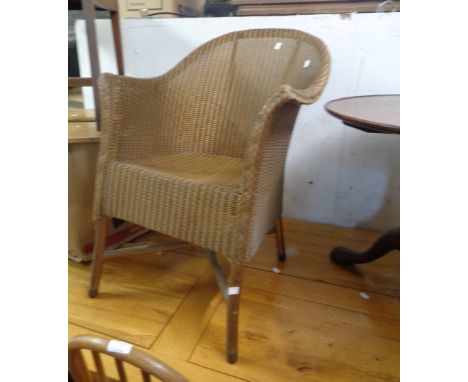 A vintage Lloyd Loom tub chair with original sprayed gold finish