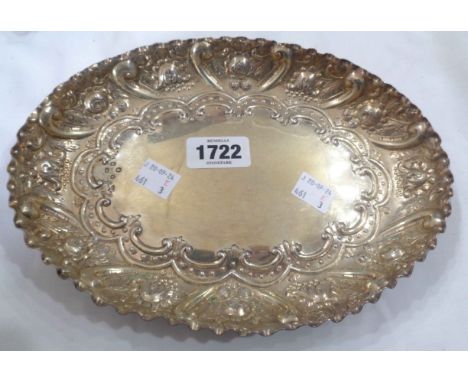 A 24cm late Victorian silver oval dressing table tray with embossed decoration and parcel gilt finish - London 1889