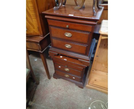 A pair of vintage Stag mahogany bedside chests, each with slide and two drawers, set on bracket feet