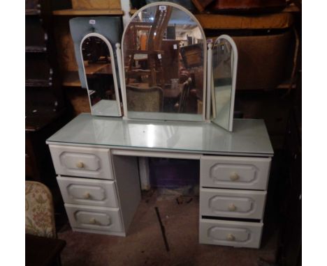 A 1.27m white painted kneehole dressing table with triple mirror and six drawers - sold with a pair of two drawer bedside che