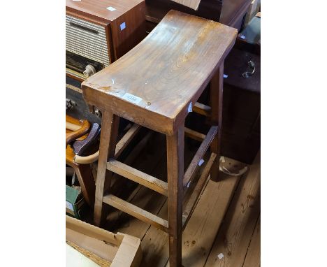 A vintage stained elm and mixed wood high stool with curved solid seat, set on square supports