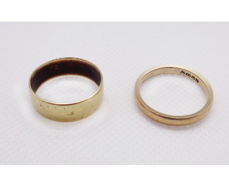 A worn 22ct. gold wedding band - sold with a 375 (9ct.) gold similar - sizes R and O respectively