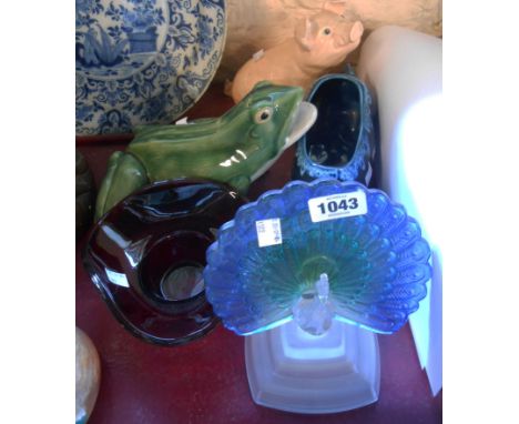 A large ceramic model of a frog - sold with two ceramic pig figurines, a glass peacock ornament and a ruby glass dish