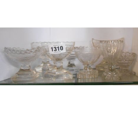Seven late 18th/early 19th Century cut glass table salts of boat form with pedestal bases - various size and pattern - sold w