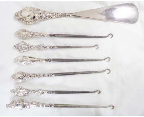 Six silver handled button hooks of varying age and design - sold with a silver handled shoehorn - wear