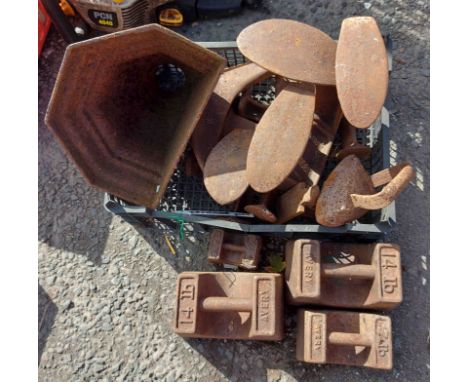 A crate containin a quantity of metal shoe lasts - sold with a drain hopper and a quantity of old Avery weights, etc.