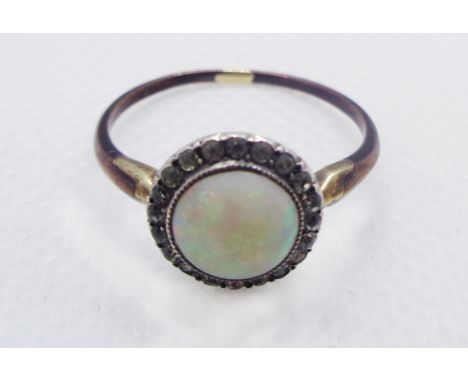 A vintage bi-metal ring, set with central circular opal cabochon within a white paste border - size S - boxed