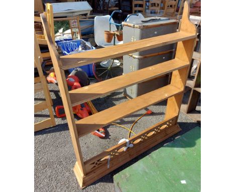 A pine shelf unit with decorative pierced apron
